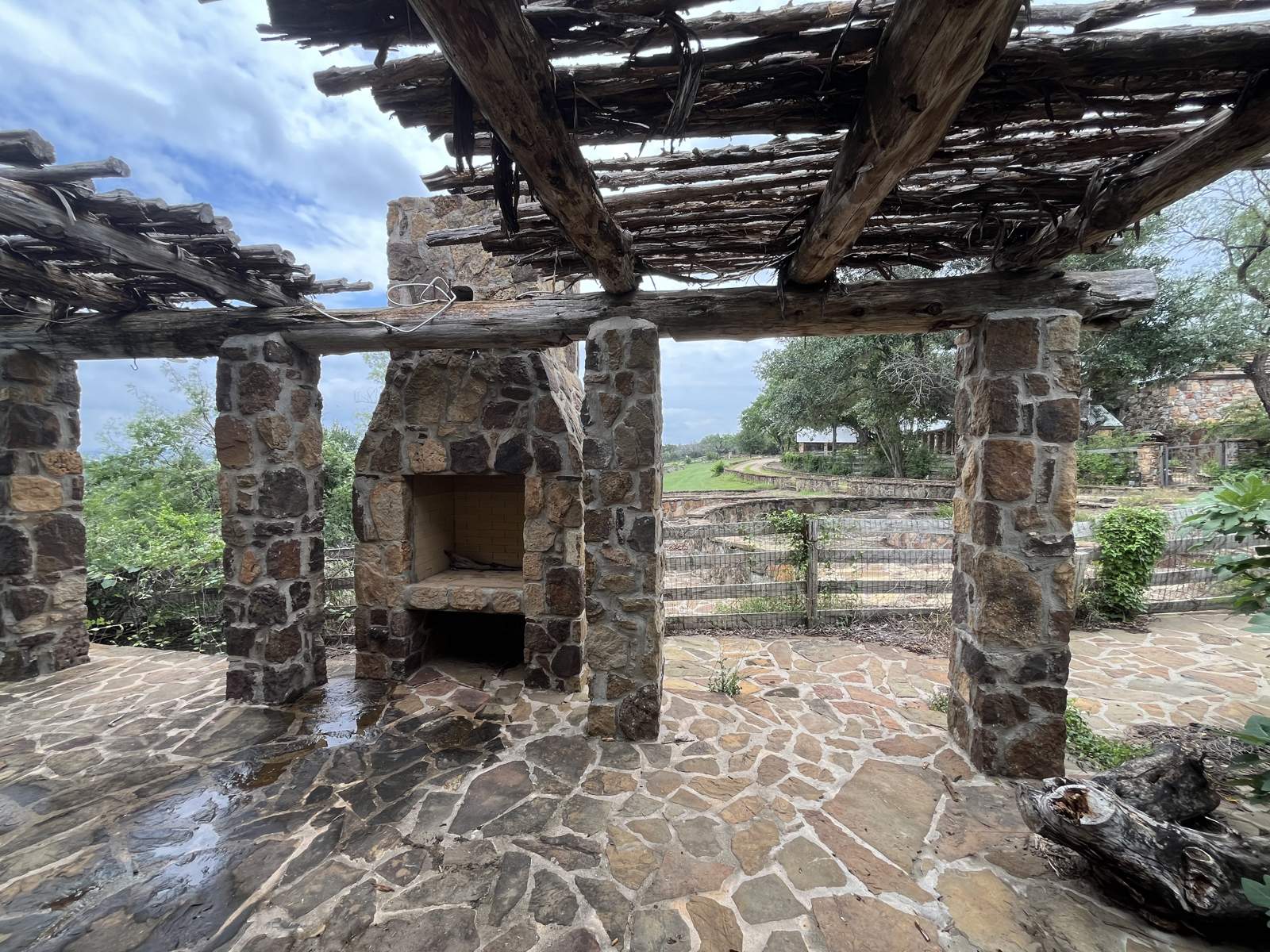 Stone pergola and fireplace at the Orchard Home