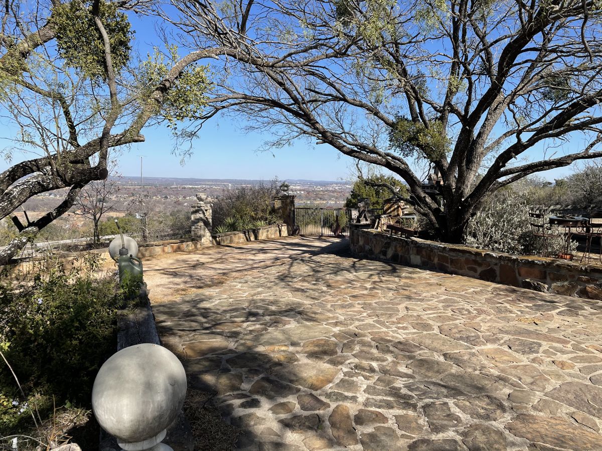 Live oaks and stone courtyard on the property
